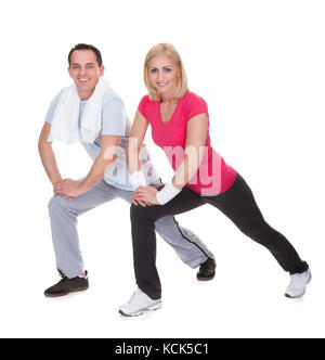Happy Young Couple Exercising Over White Background Stock Photo