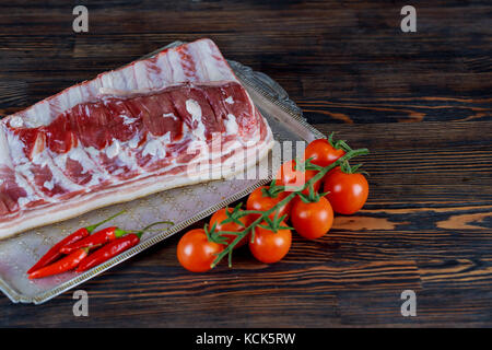 Pork ribs meat, tomato, potato, onion, garlic, chili pepper, onion, spices ready for barbecue on shale tray Stock Photo