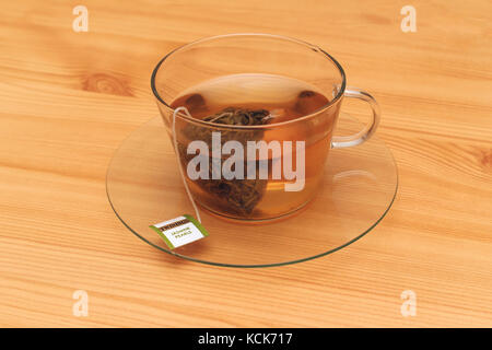 London, United Kingdom - January 11, 2015: Traditional British tea brand Twinings in transparent teacup on table during tea hour Stock Photo