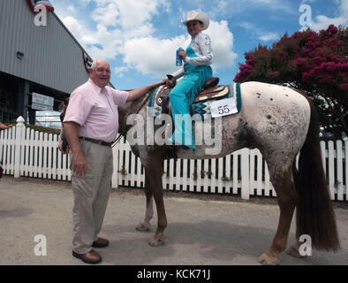 U.S. Agriculture Secretary Sonny Perdue poses with a western 4-H horseback rider during the Delaware State Fair at the Delaware State Fairgrounds July 24, 2017 in Harrington, Delaware.  (photo by Lance Cheung  via Planetpix) Stock Photo