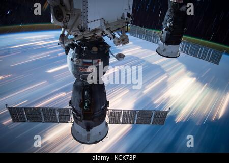 Two Russian Soyuz spacecraft capsules orbit over the night lights on Earth while docked to the NASA International Space Station March 16, 2017 in Earth orbit.  (photo by NASA Photo  via Planetpix) Stock Photo