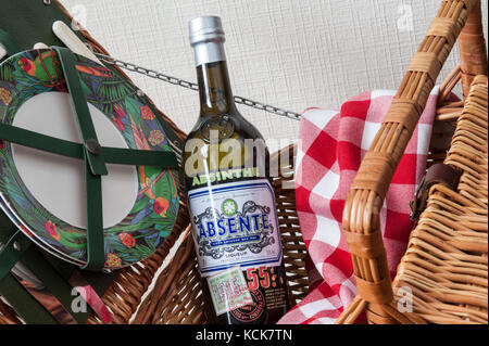 ABSINTHE BOTTLE & Picnic preparations picnic hamper basket Stock Photo