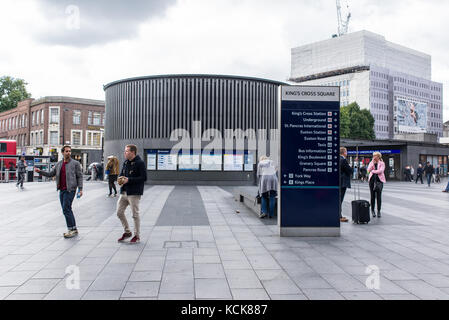 Commuters walking in King's cross Square near the underground and subway entrance, London, UK Stock Photo