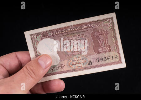 An old indian banknote on hand Stock Photo