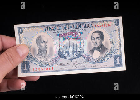 An old Colombian banknote on the hand Stock Photo