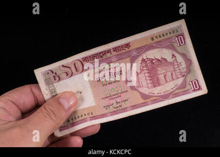 An old Bangladesh banknote on hand Stock Photo