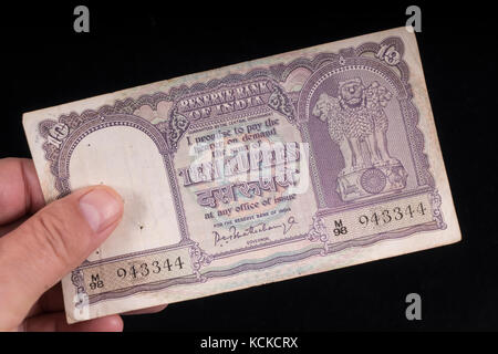 An old Indian banknote on hand Stock Photo