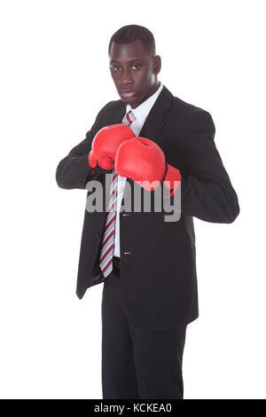 African Businessman In Boxing Gloves Over White Background Stock Photo