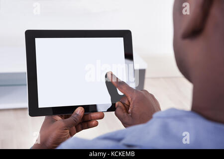 Close-up Of African Person Holding Blank Digital Tablet Stock Photo