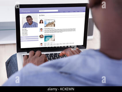 Close-up Of African Person Browsing On Laptop Stock Photo