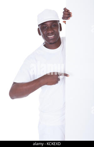 Portrait Of Male Painter Holding Blank White Banner Over White Background Stock Photo