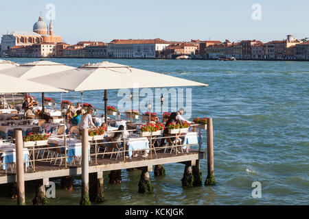 Restorante Terazza dei Nobili, Zattere, Dorsoduro, Venice, Veneto,  italy with tourists eating at an open air deck on the Giudecca Canal in evening li Stock Photo