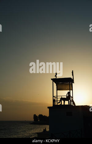 Anonymous person sitting in observation tower Stock Photo