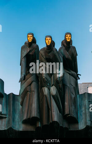 Vilnius, Lithuania, Eastern Europe - July 7, 2016: Close Up Of Black Sculpture Of Three Muses On Facade Of Lithuanian National Drama Theatre Building, Stock Photo