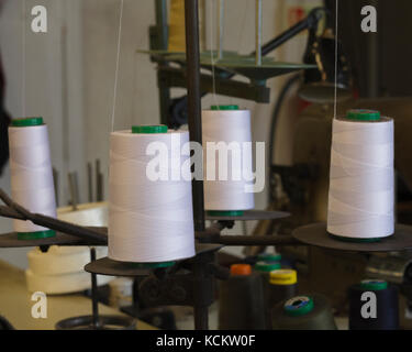 White sewing machine thread on bobbins Stock Photo