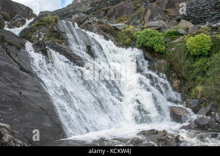 Small waterfall near Ffestiniog in North Wales with a torrent of water flowing over due to a period of heavy rain. Stock Photo