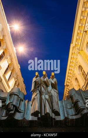 Vilnius, Lithuania - July 8, 2016: Close The Black Sculpture Of Three Muses On Facade Of Lithuanian National Drama Theatre Building, Main Entrance, Bl Stock Photo