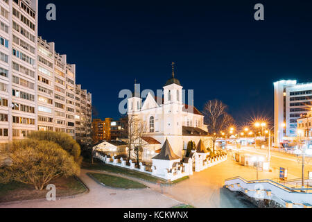 Minsk, Belarus - April 3, 2017: Evening Night View Of Cathedral of the Holy Apostles Sts Peter and Paul On Illuminated Nemiga Street. Temple of the Be Stock Photo