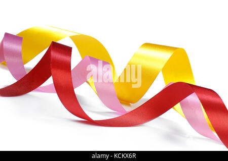 Three curled ribbons in pink, red, and yellow color Stock Photo