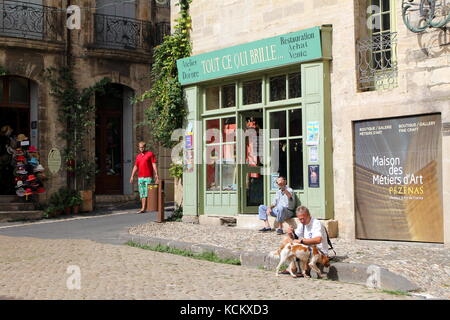 Sunny traditional cobbled street scene in the Languedoc town of Pezenas, Herault, France Stock Photo