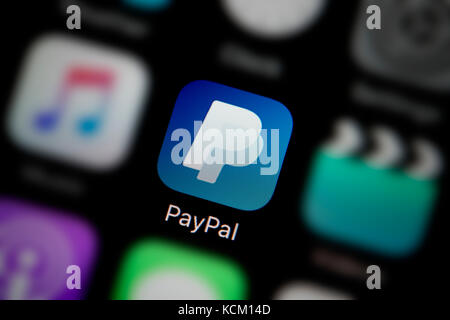 A close-up shot of the company logo representing the PayPal app icon, as seen on the screen of a smart phone (Editorial use only) Stock Photo