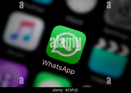 A close-up shot of the company logo representing the WhatsApp app icon, as seen on the screen of a smart phone (Editorial use only) Stock Photo