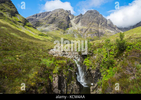 The peak of Bla Bheinn from a waterfall on the Allt na Dunaiche burn in Choire a' Caise, Isle of Skye, Scotland, UK. Stock Photo