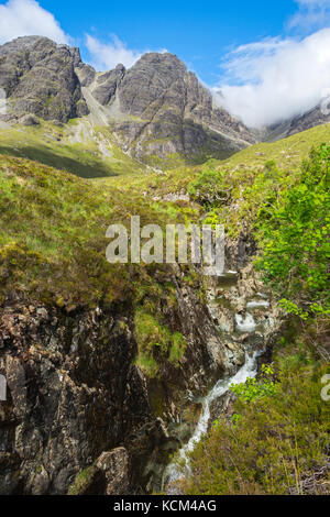 The peak of Bla Bheinn from a waterfall on the Allt na Dunaiche burn in Choire a' Caise, Isle of Skye, Scotland, UK. Stock Photo