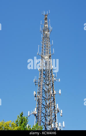 Cell phone communications tower  with multiple antennas against  clear blue sky. USA Stock Photo