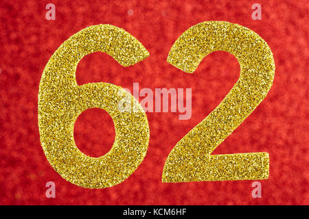 Number sixty-two golden color over a red background. Anniversary. Horizontal Stock Photo
