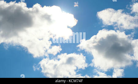 Beautiful cloudscape with large, building clouds and sunrise breaking through cloud mass Stock Photo