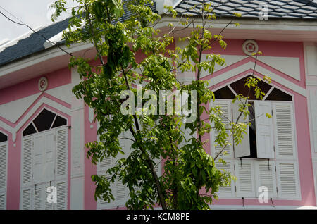 Retro white wooden window on antique pink building at retro town in Nonthaburi, Thailand Stock Photo