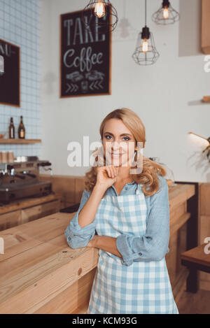 beautiful cafe owner in apron Stock Photo