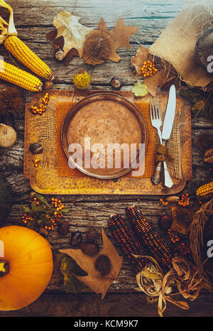 Thanksgiving day dinner. Autumn fruit with plate and cutlery. Thanksgiving autumn background Stock Photo
