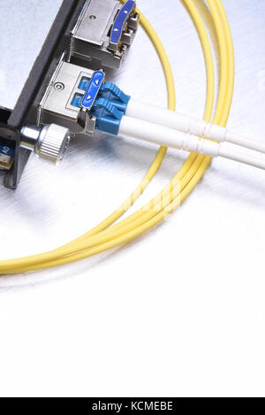 Gigabit interface converter type XFP with optical network cables on metal grey background with copy space Stock Photo