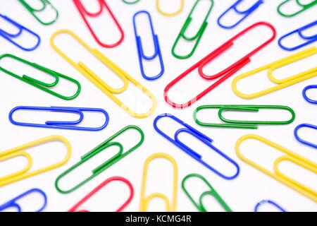 Close Up of Brightly Colored Paperclips on White Background Stock Photo