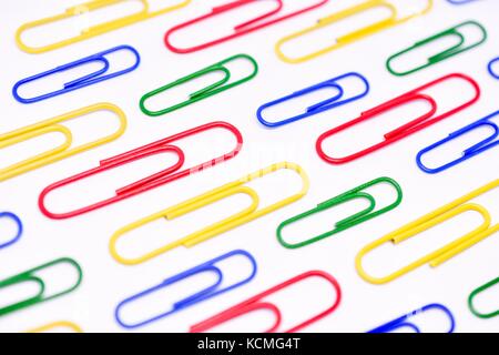 Close Up of Brightly Colored Paperclips on White Background Stock Photo