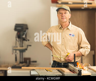 Senior caucasian man in home workshop with voting sticker Stock Photo