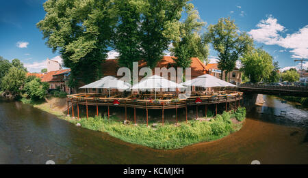 Vilnius, Lithuania - July 5, 2016: Panoramic View Of Street Cafe In Uzupis District Located In Old Town Of Vilnius. District Of Vilniaus Senamiestis. Stock Photo
