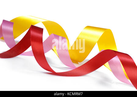 Three curled ribbons in pink, red, and yellow color Stock Photo