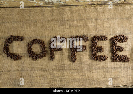 Word coffee arranged with coffee beans on fabric Stock Photo