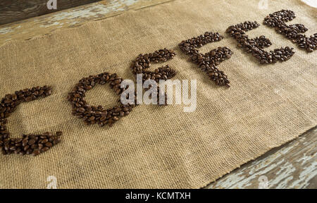 Word coffee arranged with coffee beans on fabric Stock Photo