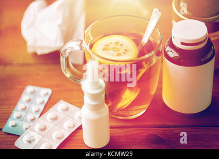 cup of tea, drugs, honey and paper tissue on wood Stock Photo