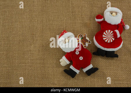 Overhead view of stuffed Santa Claus on burlap Stock Photo