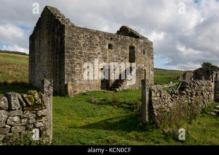 Exterior of the best preserved Grade 2 listed Bastle (a fortified 18th/19th century farmhouse) at Black Middens, on 28th September 2017, in Gatehouse, Northumberland, England. Bastel, bastle, or bastille houses are a type of construction found along the Anglo-Scottish border, in the areas formerly plagued by border Reivers. Typically, the bastle was 10-12 metres long by 5-6 metres wide with walls up to 1.6 metres thick. Some 400 tonnes of sandstone blocks were needed for construction with corner quoins (corner stones) weighing up to 300kg. Bastles would have been costly to build so afforded by Stock Photo