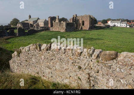 The landscape surrounding the early 12th century Lindisfarne Priory on Holy Island, on 27th September 2017, on Lindisfarne Island, Northumberland, England. The monastery of Lindisfarne was founded by Irish monk Saint Aidan, and the priory was founded before the end of 634 and Aidan remained there until his death in 651. The Holy Island of Lindisfarne, also known simply as Holy Island, is an island off the northeast coast of England. Holy Island has a recorded history from the 6th century AD; it was an important centre of Celtic and Anglo-saxon Christianity. After the Viking invasions and the N Stock Photo