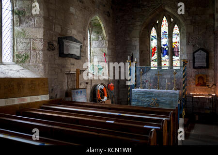Featuring paraphenalia of local fishing industry, the interior of St. Mary's church on Holy Island, on 27th September 2017, on Lindisfarne Island, Northumberland, England. The Holy Island of Lindisfarne, also known simply as Holy Island, is an island off the northeast coast of England. Holy Island has a recorded history from the 6th century AD; it was an important centre of Celtic and Anglo-saxon Christianity. After the Viking invasions and the Norman conquest of England, a priory was reestablished. Stock Photo