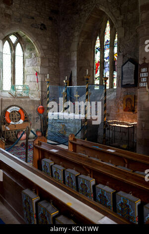 Featuring paraphenalia of local fishing industry, the interior of St. Mary's church on Holy Island, on 27th September 2017, on Lindisfarne Island, Northumberland, England. The Holy Island of Lindisfarne, also known simply as Holy Island, is an island off the northeast coast of England. Holy Island has a recorded history from the 6th century AD; it was an important centre of Celtic and Anglo-saxon Christianity. After the Viking invasions and the Norman conquest of England, a priory was reestablished. Stock Photo