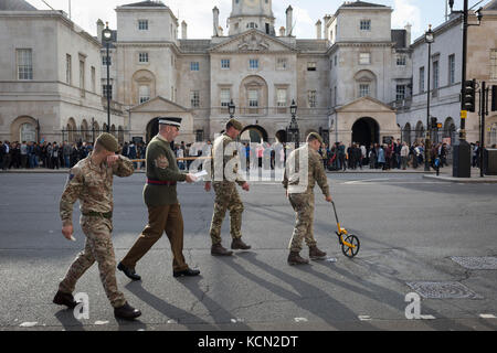 According to protocol, members of the Coldstream Guards, led by 'H. M. Ceremonial Warrant Officer WO1 (GSM) Andrew 'Vern' Stokes, mark in chalk the route along Whitehall for a future ceremony, on 5th October, 2017, in London, England. Stock Photo