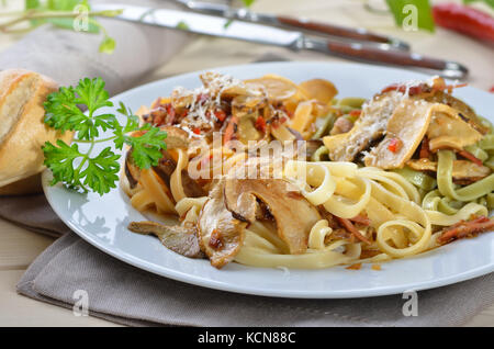 Tagliatelle with boletus and bacon sauce with wine Stock Photo